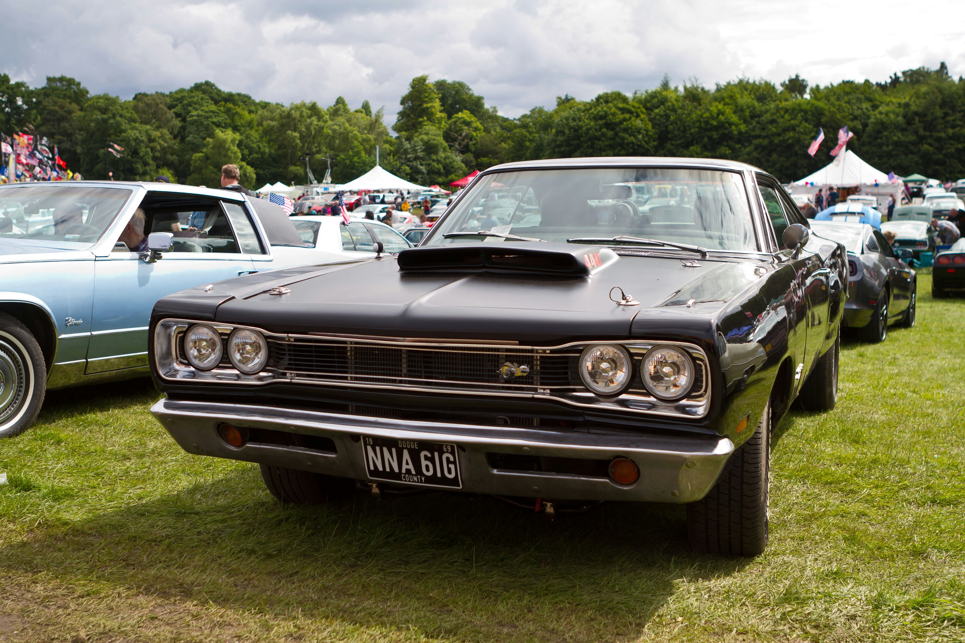 Classic American muscle car at a Midwest car show on a sunny afternoon