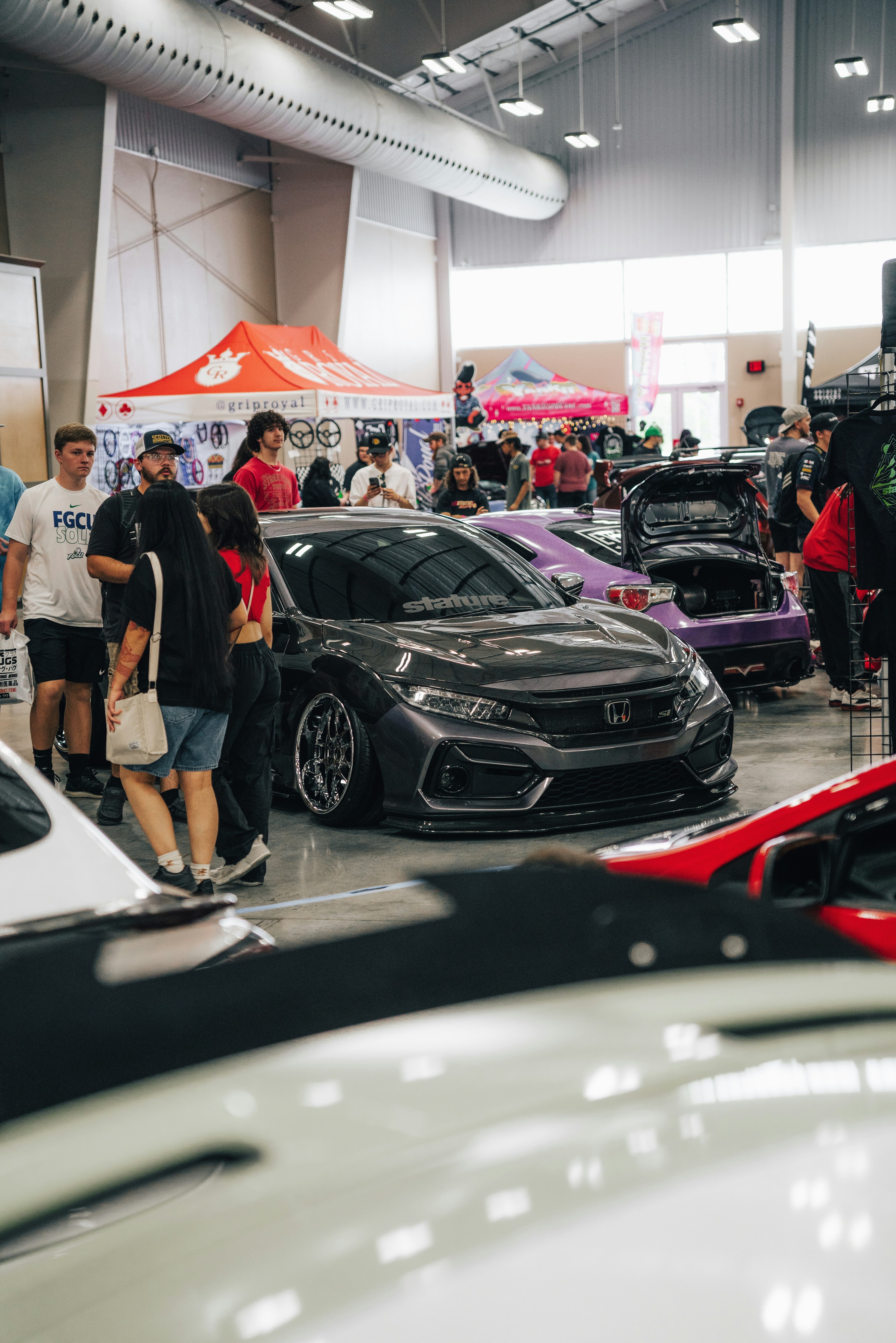 Group of modified cars lined up at a car show in St. Louis