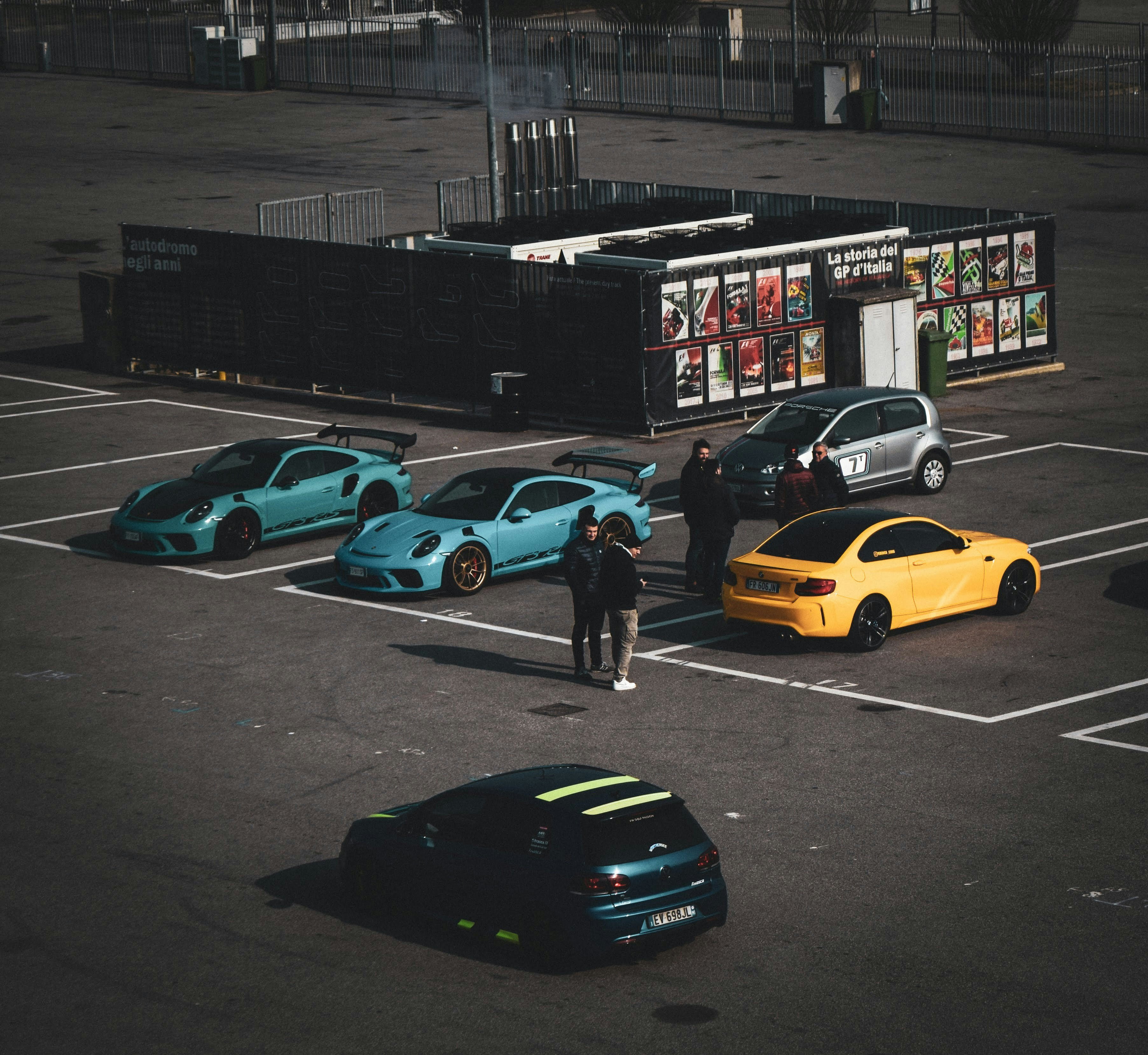 Morning car meet with coffee cups and sports cars in parking lot